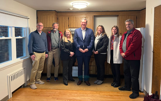 image of staff posing with Secretary Ed Augustus